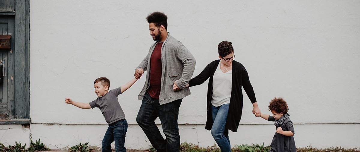 Family walking on sidewalk