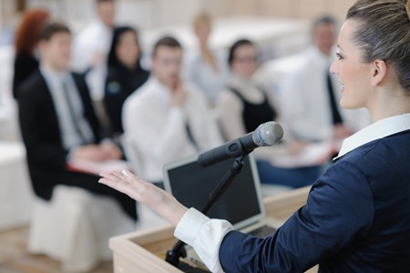 Woman presenting to small group of people